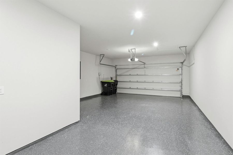 The attached two-car garage offers abundant space for vehicles, storage, and hobbies. An epoxy-coated floor provides a durable, low-maintenance finish while the automatic garage door opener adds everyday convenience.