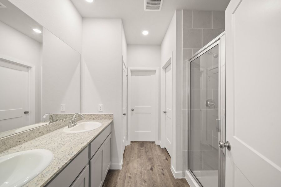 A bathroom with a sink and a shower.