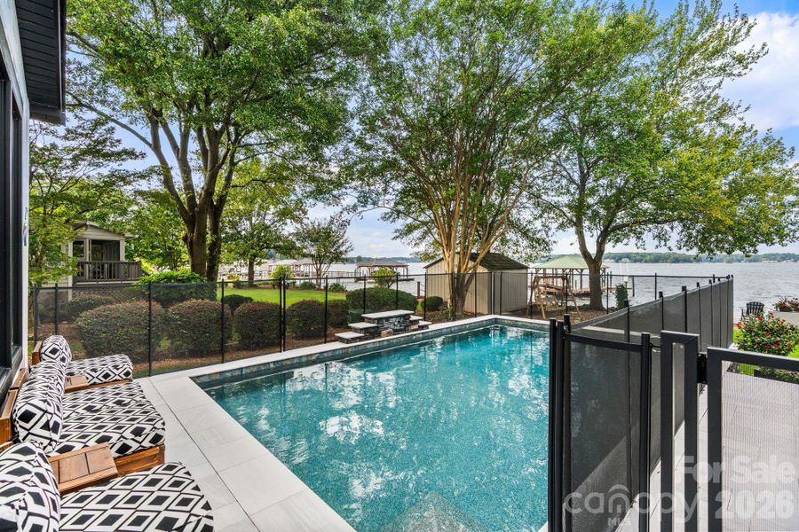 Black safety fencing provides security while enjoying the pool Black safety fencing provides security while enjoying the pool