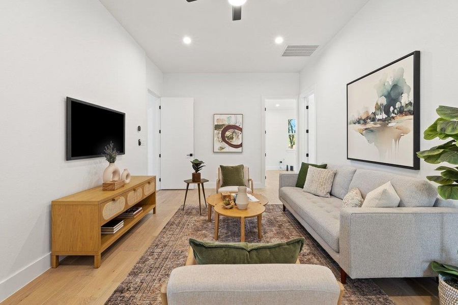 Living area featuring wood finished floors, ceiling fan, and recessed lighting