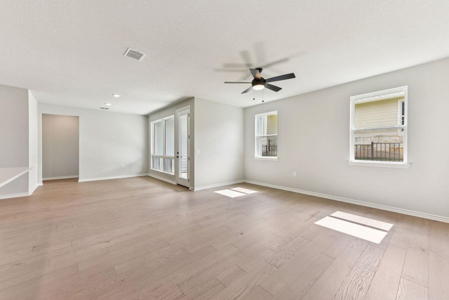 Spare room with light wood-style flooring and a ceiling fan