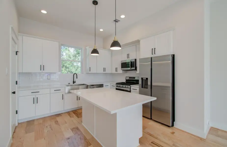 Your open-concept kitchen was made for connection and celebration. Overlook the expansive living area while preparing meals in this thoughtfully designed space—complete with sleek counters, upgraded appliances, and modern fixtures that shine under soft ambient lighting.