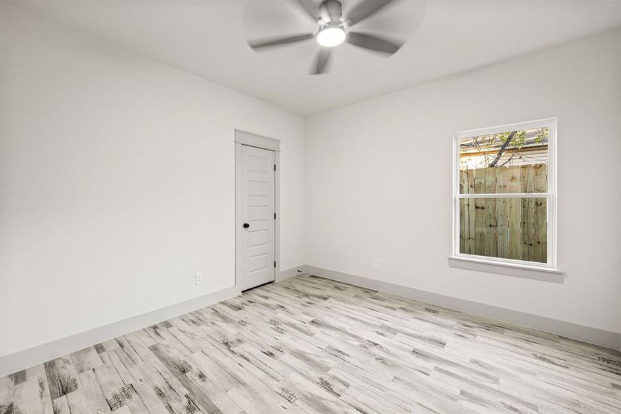 Unfurnished room featuring light wood finished floors and a ceiling fan Unfurnished room featuring light wood finished floors and a ceiling fan