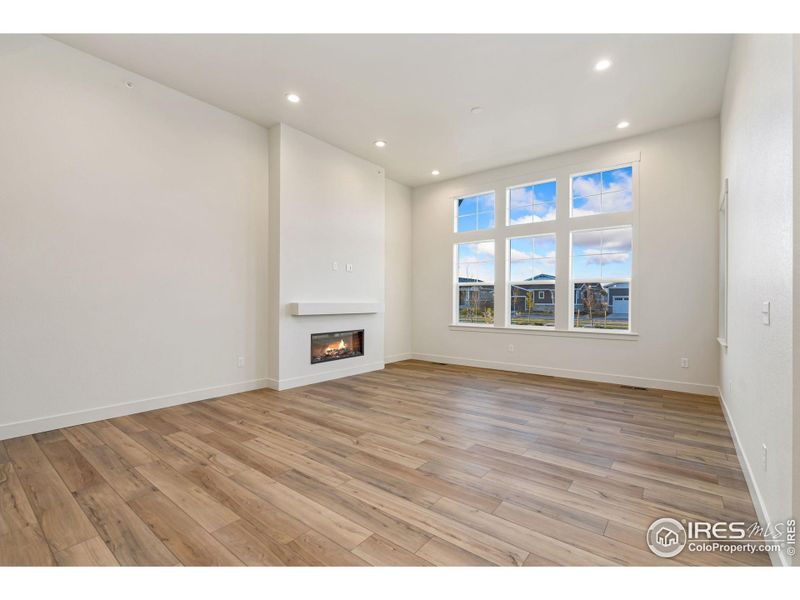 Large windows for plenty of natural light - electric fireplace with mantel