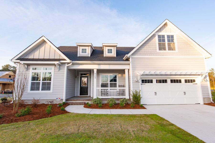 Representative exterior photo of a completed home built from the Helmsley by Bill Clark Homes in The Sanctuary at Sunset Beach, Sunset Beach, NC (Image 23). Representative exterior photo of a completed home built from the Helmsley by Bill Clark Homes in The Sanctuary at Sunset Beach, Sunset Beach, NC (Image 23).