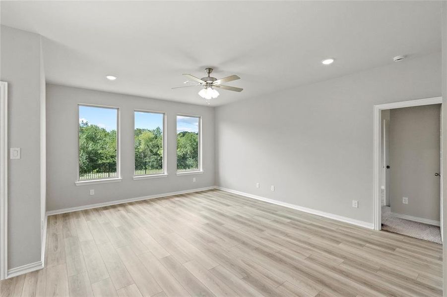 Spare room featuring light wood-type flooring and ceiling fan