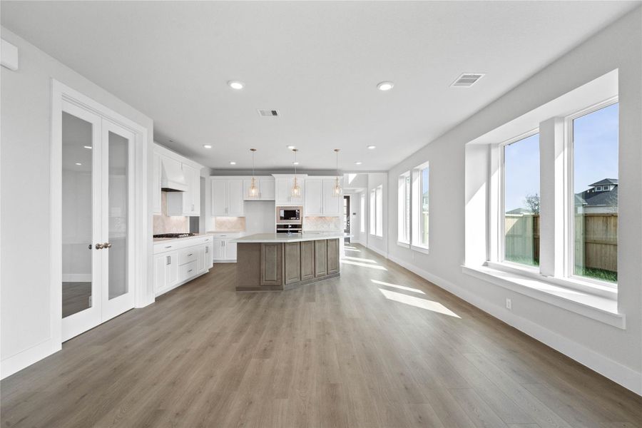 Create lasting memories around the table with family and friends in the dining! It showcases high ceilings, large windows, wood flooring, and recessed lighting for a warm and welcoming atmosphere.