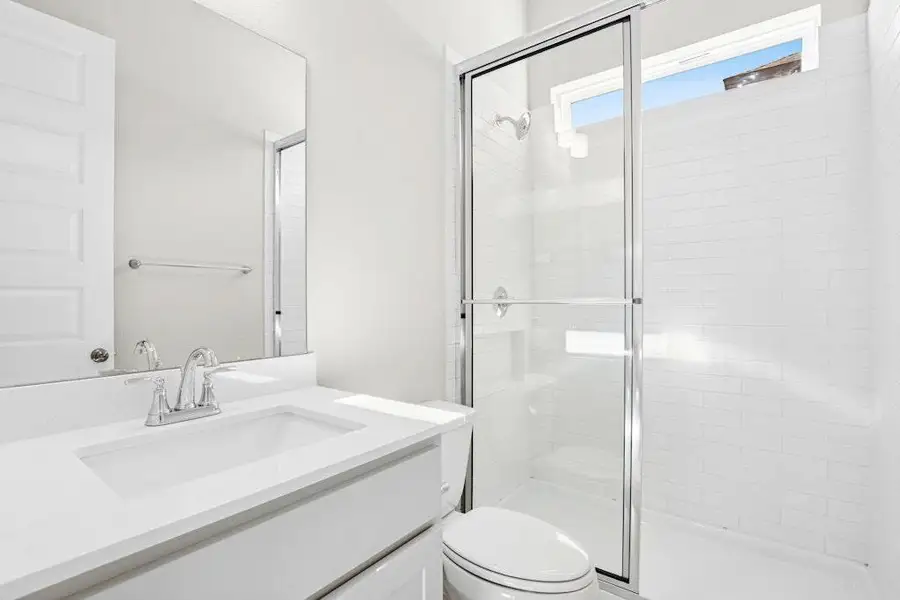 Full bath featuring vanity and a shower stall Full bath featuring vanity and a shower stall