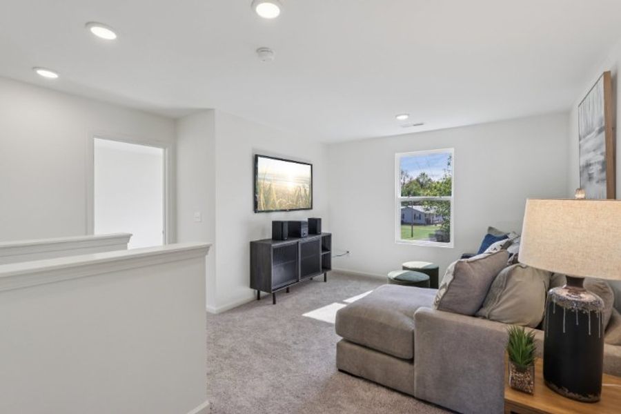 A living room with a couch and a tv.