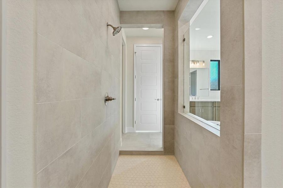 Hallway featuring tile patterned flooring, recessed lighting, and tile walls
