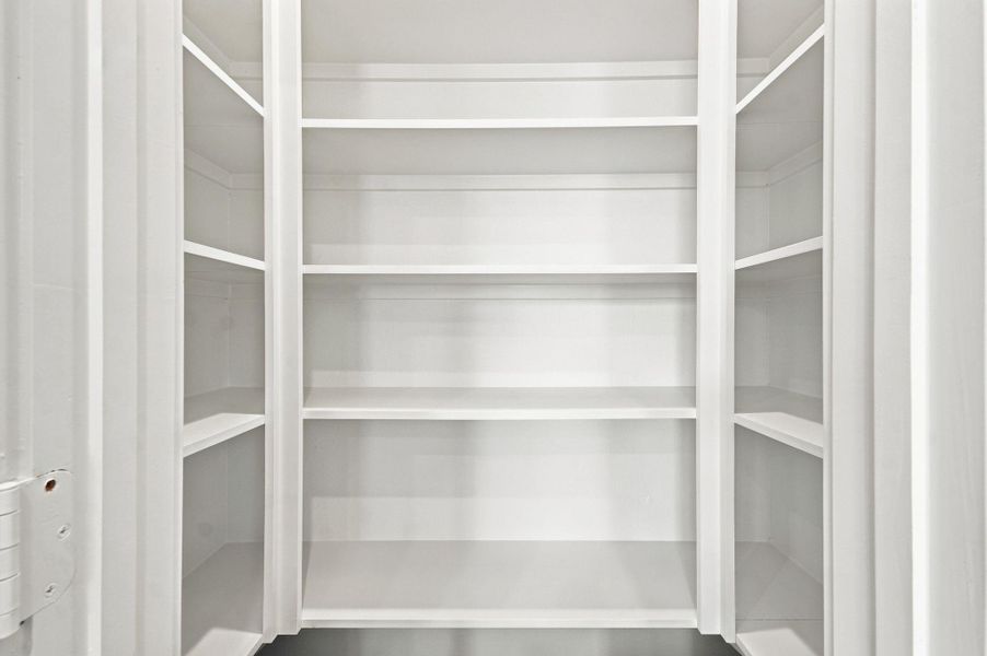 Another view of the convenient walk-in pantry with built-in shelving and ample storage space. Another view of the convenient walk-in pantry with built-in shelving and ample storage space.
