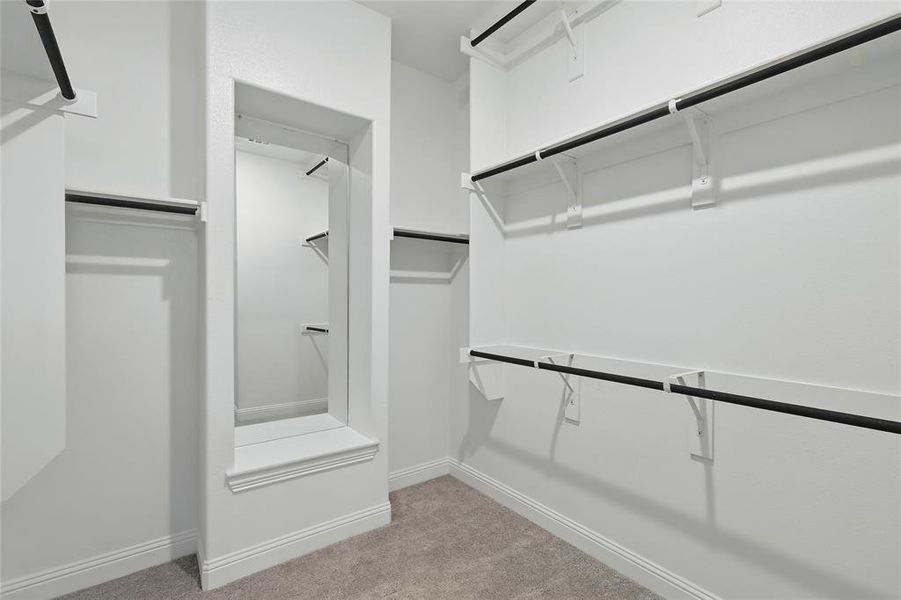 Walk in closet featuring light colored carpet Walk in closet featuring light colored carpet