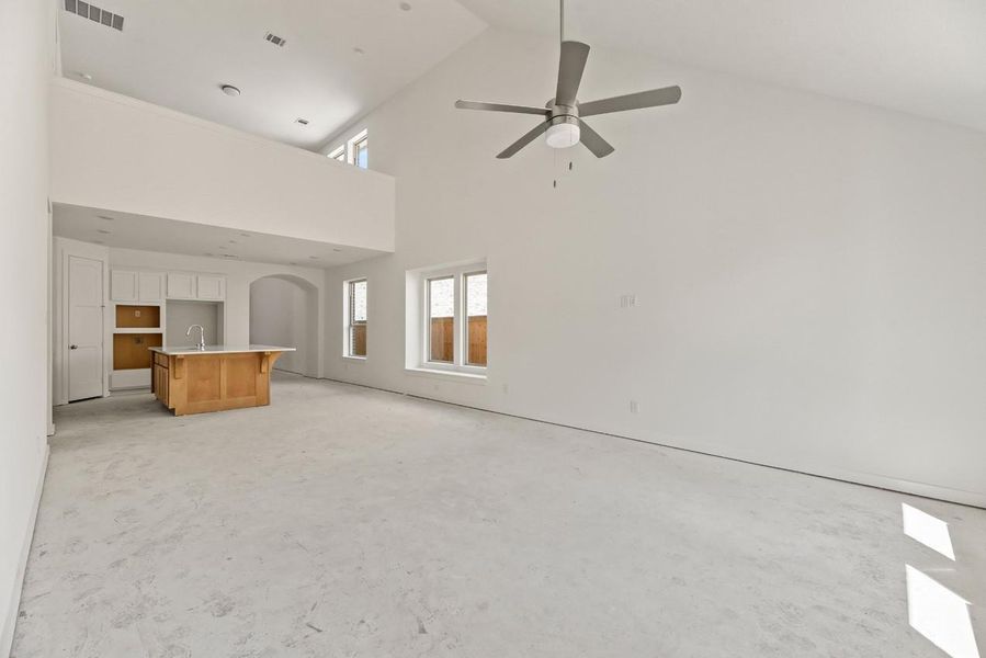 The family room, dining area, and kitchen flow seamlessly together beneath soaring open-to-below ceilings, creating the ultimate space for both connection and relaxation. The family room, dining area, and kitchen flow seamlessly together beneath soaring open-to-below ceilings, creating the ultimate space for both connection and relaxation.
