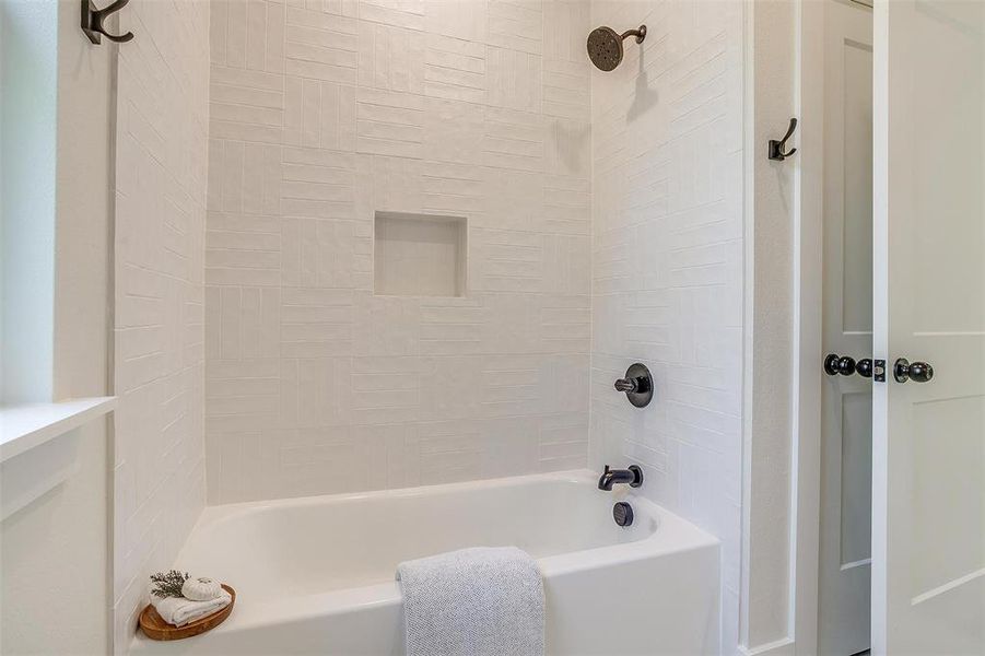 The shower features more custom tile work.