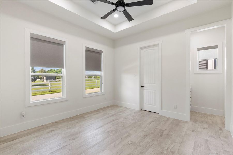 Bedroom 5 offers a large space with 2 large windows for natural light. A black ceiling fan and a tray ceiling. It also has an on-suite bath. Bedroom 5 offers a large space with 2 large windows for natural light. A black ceiling fan and a tray ceiling. It also has an on-suite bath.