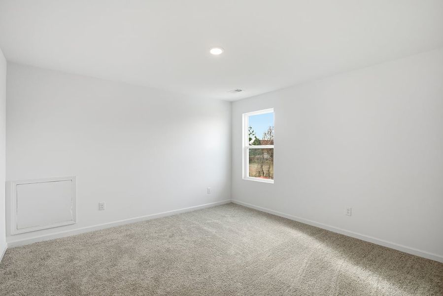 A room with a window and a carpet. A room with a window and a carpet.