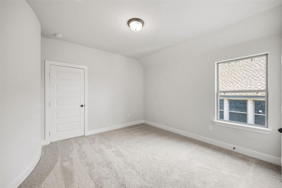 Empty room with light carpet and baseboards Empty room with light carpet and baseboards