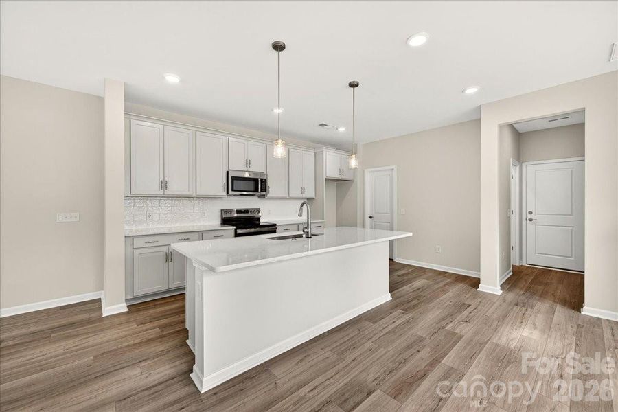 Light filled kitchen with white quartz countertops Light filled kitchen with white quartz countertops