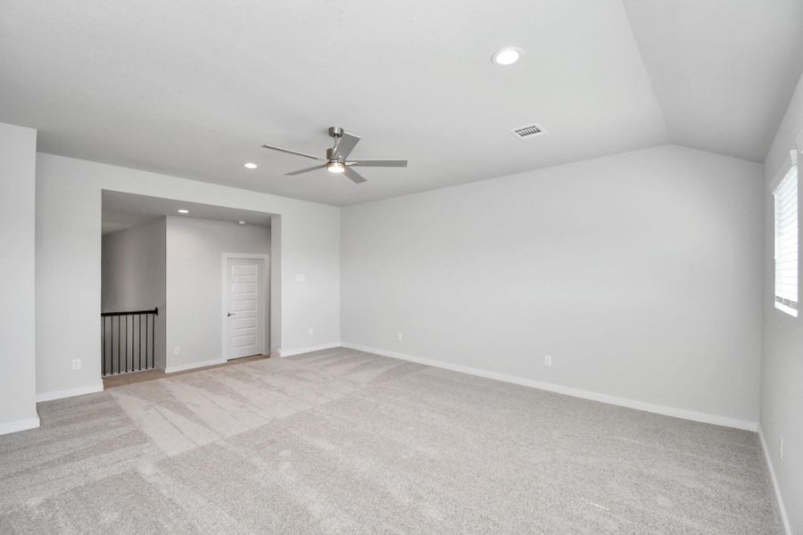 Discover a haven of leisure in this fantastic game room! Whether you're seeking a casual hangout or an adult gaming retreat, this space has it all. Enjoy the luxurious feel of plush carpet underfoot, the expansive ambiance of high ceilings, custom paint that adds a touch of personality, and windows that flood the room with refreshing natural light. Sample photo of completed home with similar floor plan. Actual colors and selections may vary.