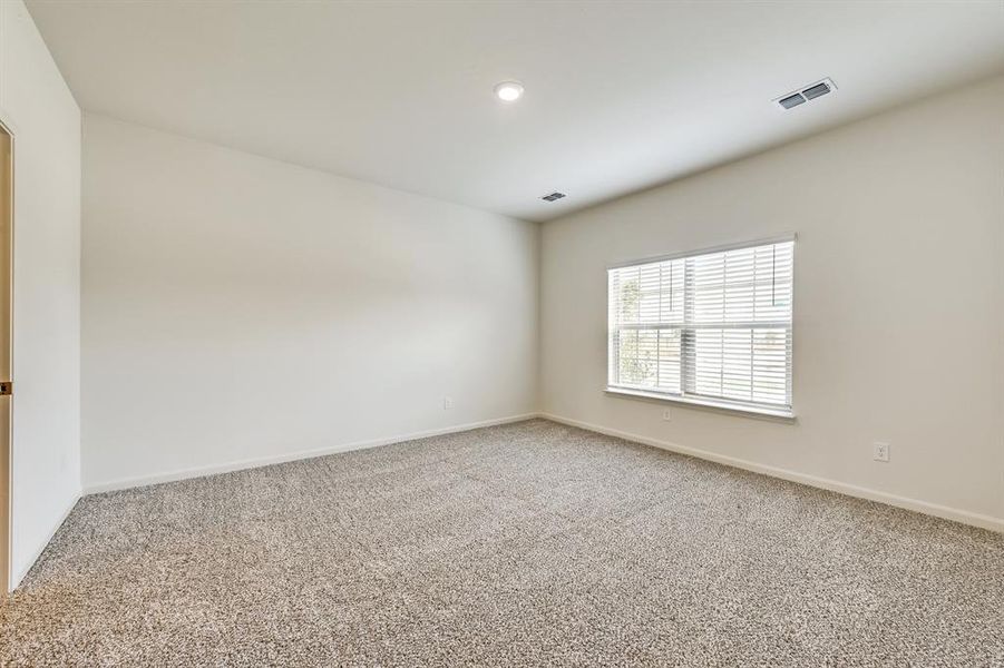 View of carpeted primary bedroom