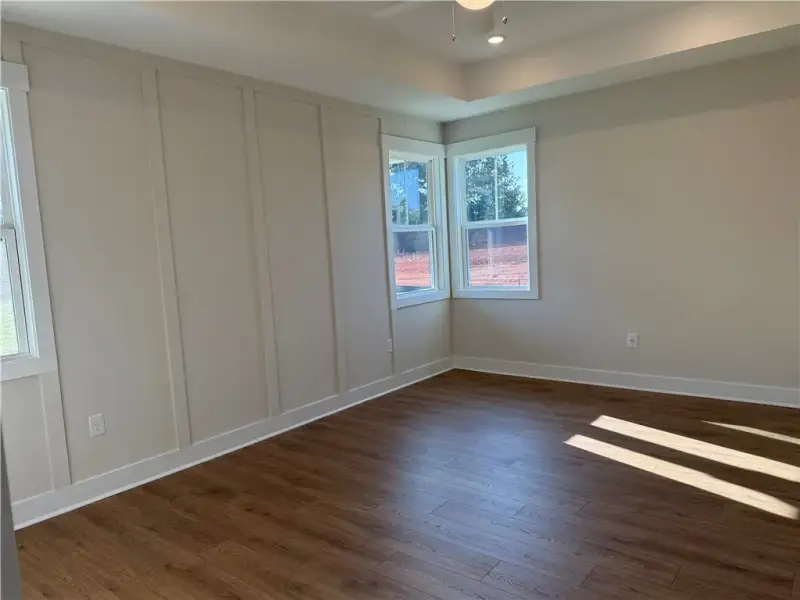 Rich wood floors meet custom board and batten wall