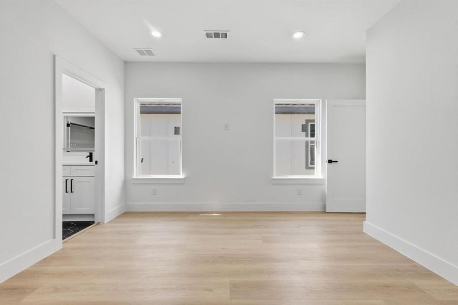 Unfurnished room featuring light wood-style floors and recessed lighting Unfurnished room featuring light wood-style floors and recessed lighting
