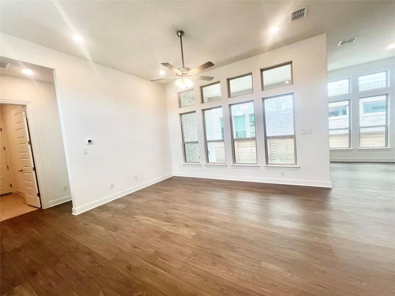 Unfurnished living room featuring dark wood-style floors, recessed lighting, and ceiling fan Unfurnished living room featuring dark wood-style floors, recessed lighting, and ceiling fan