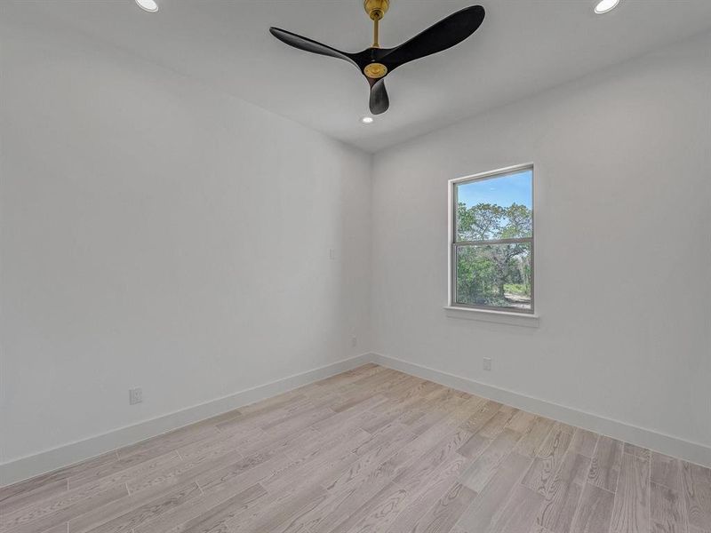 Empty room featuring recessed lighting, light wood-type flooring, and a ceiling fan