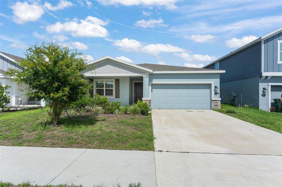 Front exterior of a new home in Peace Creek Reserve, Winter Haven, FL, highlighting curb appeal (Image 20).