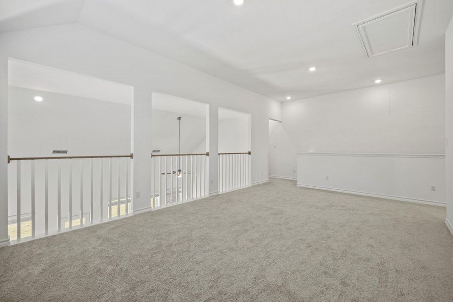 Carpeted spare room with attic access, recessed lighting, vaulted ceiling, and ceiling fan