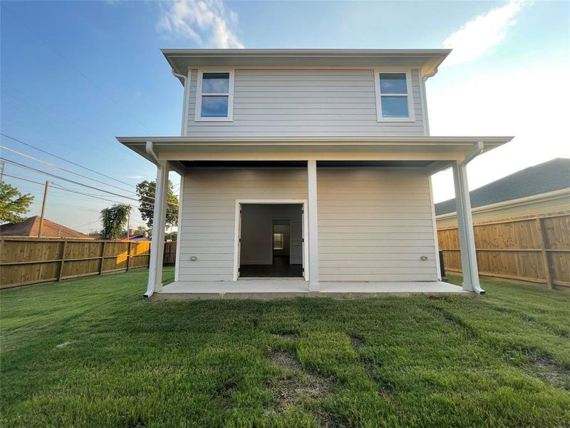Rear view of house with a patio and a fenced backyard Rear view of house with a patio and a fenced backyard