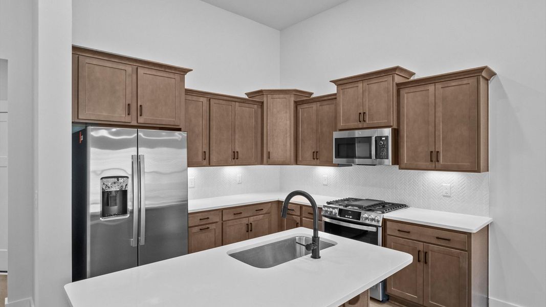 Stylish and efficient kitchen with a modest island and sleek, current design