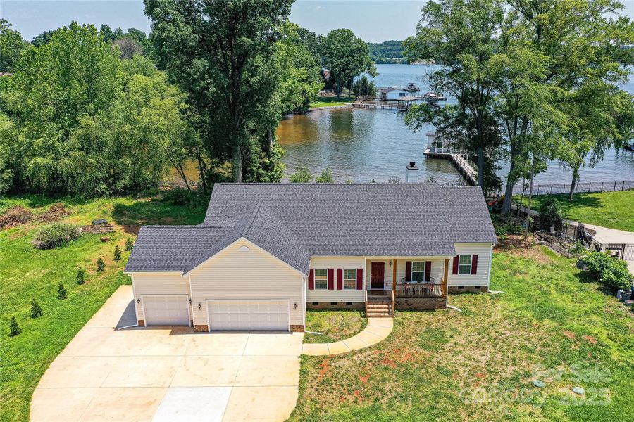 Aerial View of Waterfront, Custom Designed Home with 3 Bedroom, 2.5 Bath, Ranch & 3 Car Garage, with views of Lake from front & back of home, located on Kiser Island with NO HOA!