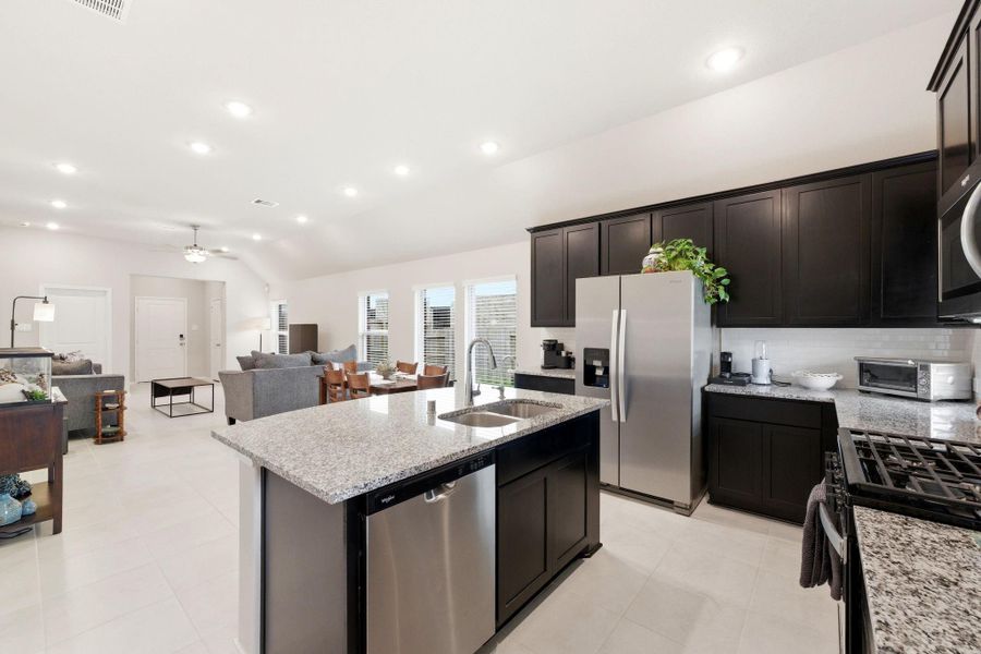 Island kitchen allows for additional seating area at the bar.