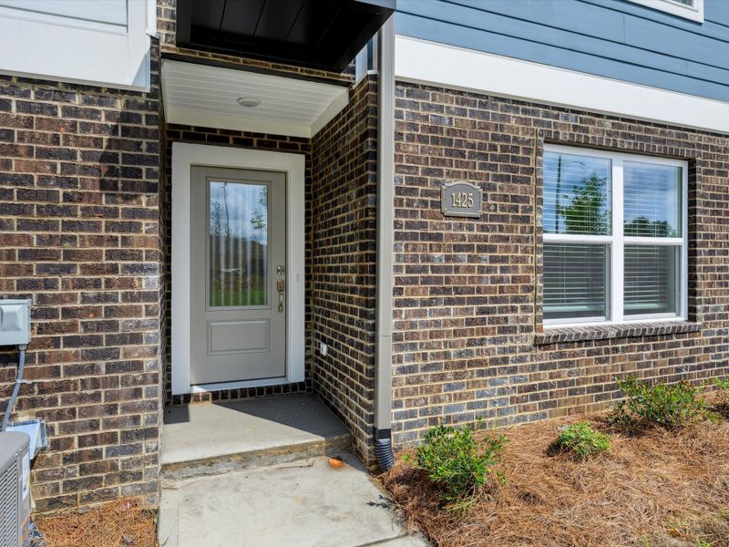 Exterior details and patio area of a home in Central Living at Craig, Charlotte (Image 3).