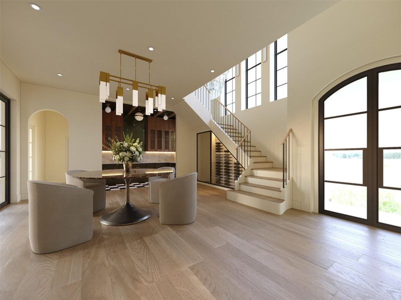 The grand foyer leads you into your dining area which includes a wine display underneath the staircase and a decadant wet bar. Framed by soaring ceilings and oversized black-trimmed grid windows, this elegant dining space features wide-plank white oak flooring, a sculptural table beneath a statement brass chandelier, and custom glass enclosed wine display tucked beneath the staircase. The grand foyer leads you into your dining area which includes a wine display underneath the staircase and a decadant wet bar. Framed by soaring ceilings and oversized black-trimmed grid windows, this elegant dining space features wide-plank white oak flooring, a sculptural table beneath a statement brass chandelier, and custom glass enclosed wine display tucked beneath the staircase.