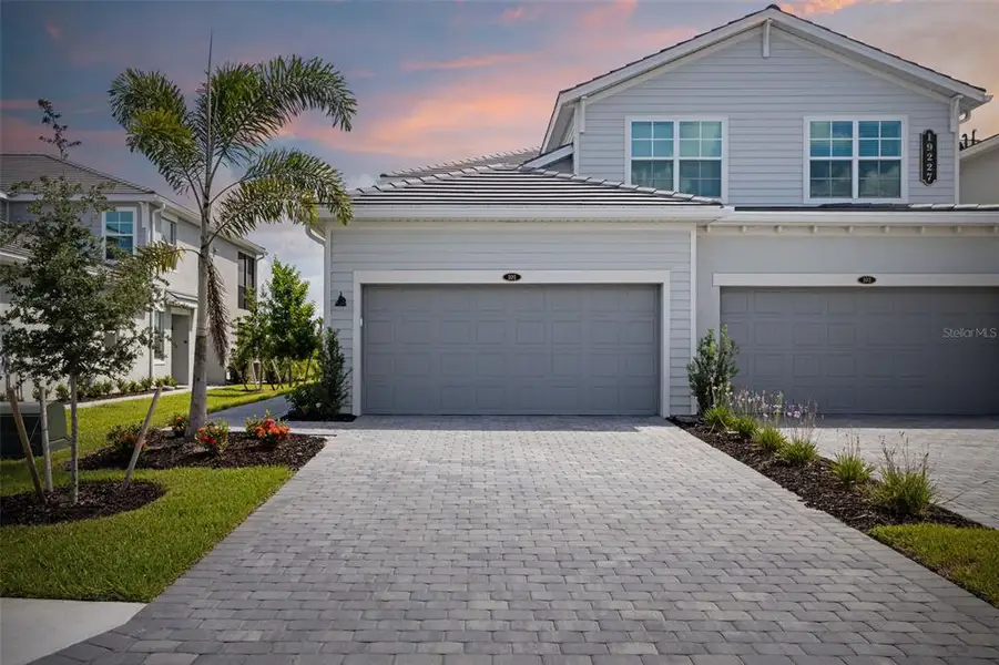 Front exterior of a new home in Calusa Country Club, Lakewood Ranch, FL, highlighting curb appeal (Image 2).