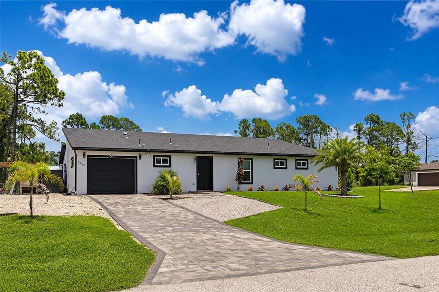 Front exterior of a new home in , North Port, FL, highlighting curb appeal (Image 1). Front exterior of a new home in , North Port, FL, highlighting curb appeal (Image 1).