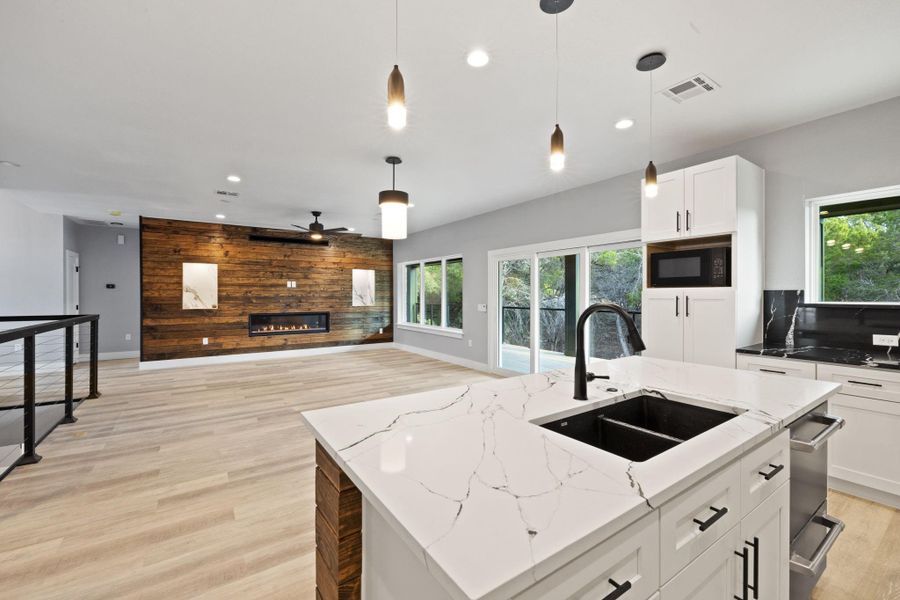 Quartz countertops in the kitchen and a touch faucet are just the beginning here.