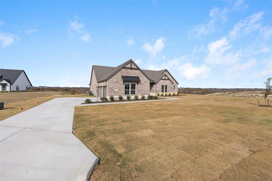 Front exterior of a new home in Eagle Ridge Estates, Weatherford, TX, highlighting curb appeal (Image 23).