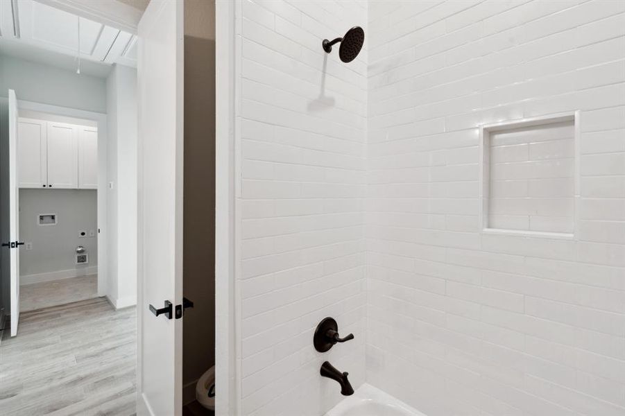 The shared bathroom also has a tub/shower combo with functional cubby for bathroom essentials.