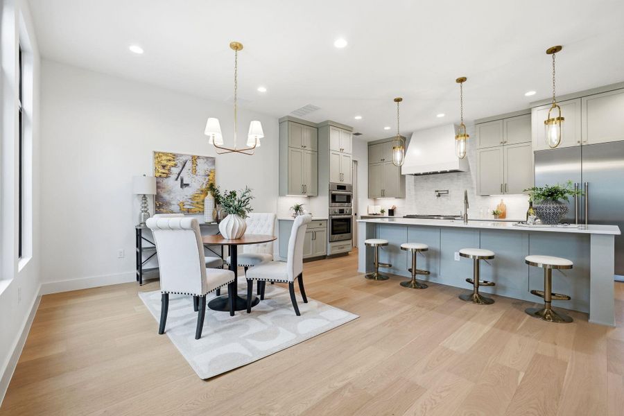 Dining space featuring light wood-style floors and hanging lights