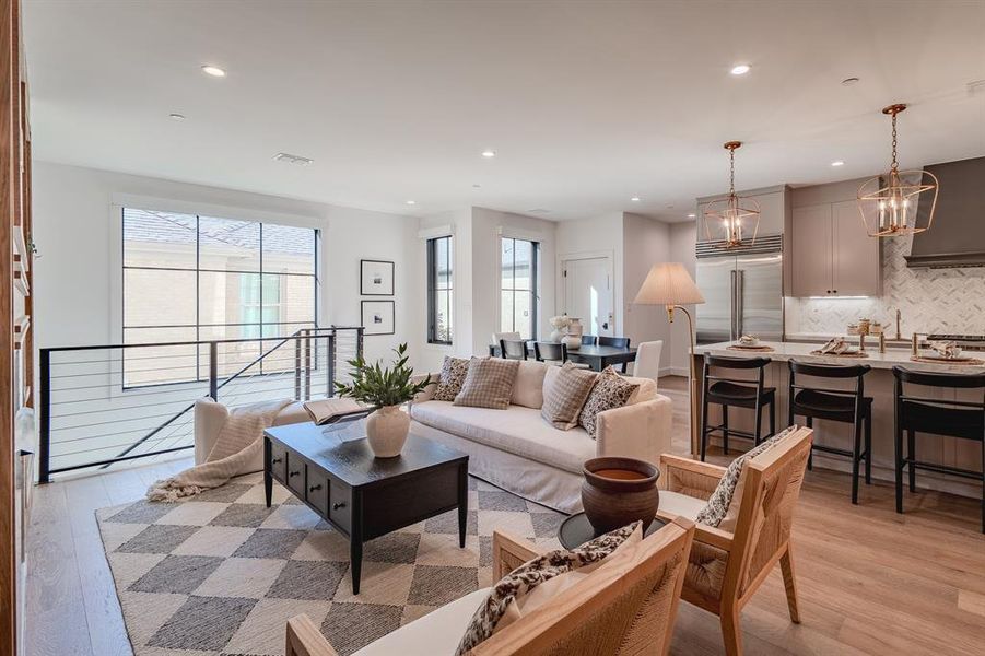 Living room featuring light wood finished floors and recessed lighting Living room featuring light wood finished floors and recessed lighting