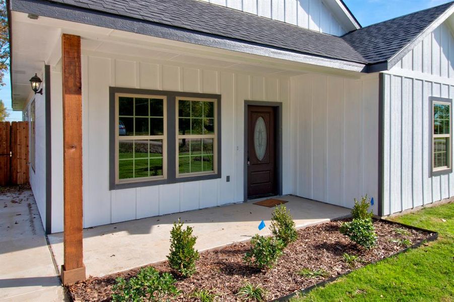 Doorway to property featuring covered porch