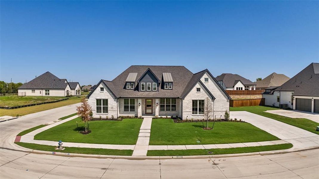 View of front of home with brick siding, covered porch, driveway, a shingled roof, and a residential view