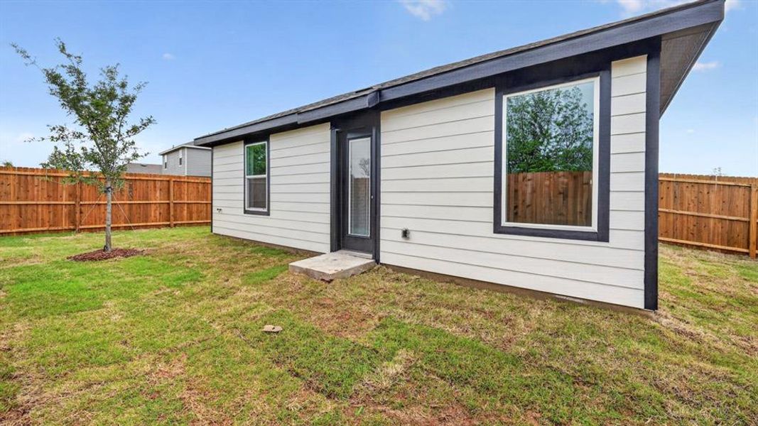 Contemporary exterior with horizontal siding, dark trim, and a sloped roofline