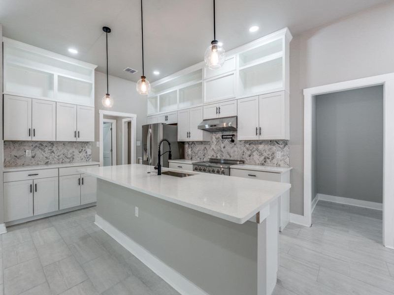 Kitchen featuring open shelves, tasteful backsplash, pendant lighting, and white cabinets