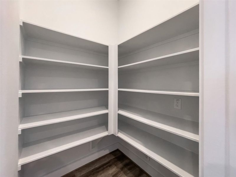Spacious walk-in pantry with ample shelving for all your kitchen essentials.