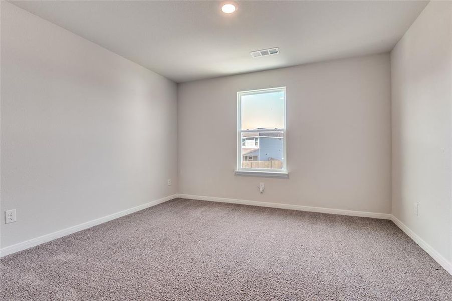 Empty room with light carpet and baseboards