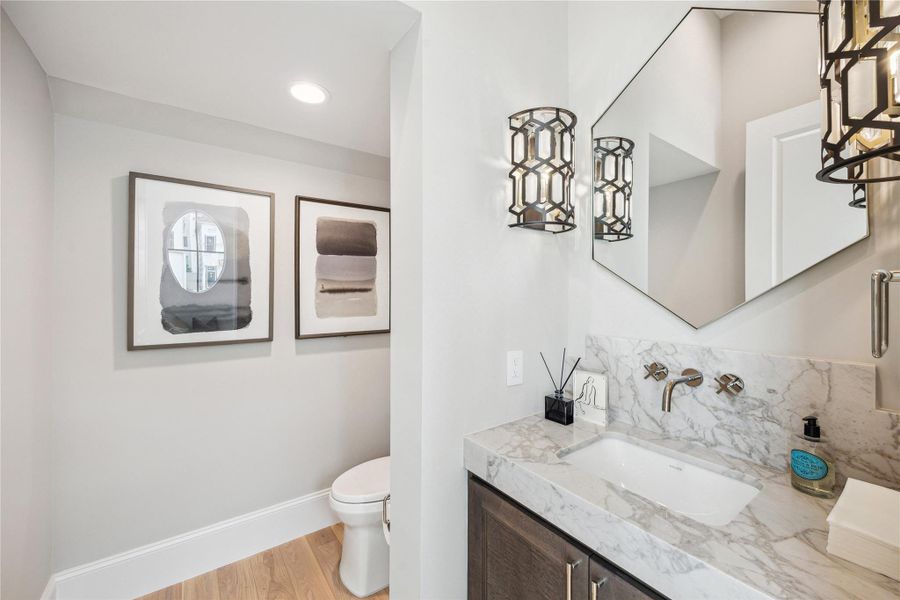 First floor powder features Florence Polished Marble countertop, Kallista luxury fixtures and undermount sink, and additional storage. First floor powder features Florence Polished Marble countertop, Kallista luxury fixtures and undermount sink, and additional storage.